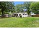 Well-maintained home with a spacious lawn and mature trees providing ample shade at 1109 S Highland Ave, Landis, NC 28088