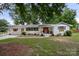 Charming single-story home with brick exterior, front porch, and landscaped yard at 1109 S Highland Ave, Landis, NC 28088