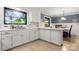 Kitchen with white cabinets, marble counters, tile backsplash and a view to the dining area at 1109 S Highland Ave, Landis, NC 28088