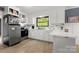 Bright kitchen with stainless steel appliances, marble countertops, and white cabinetry at 1109 S Highland Ave, Landis, NC 28088