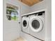 Modern washer and dryer set with exterior door and a glimpse of the outdoors at 1109 S Highland Ave, Landis, NC 28088
