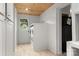 Convenient laundry room with side-by-side washer and dryer, wooden ceiling, and access to an exterior door at 1109 S Highland Ave, Landis, NC 28088