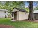 View of an outbuilding with matching trim, a small covered porch and a dark roof at 1109 S Highland Ave, Landis, NC 28088