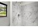 Elegant marble-tiled shower stall with a chrome showerhead and window at 1109 S Highland Ave, Landis, NC 28088