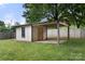 Enclosed backyard structure with open side access, and mature trees in background at 1109 S Highland Ave, Landis, NC 28088