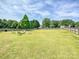 Aerial view of a sprawling backyard with a fire pit area and well-maintained lawn, ideal for outdoor activities at 1109 Woodwinds Dr, Waxhaw, NC 28173