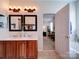 Bright and functional bathroom with double vanity and an open doorway to the Primary bedroom at 1109 Woodwinds Dr, Waxhaw, NC 28173