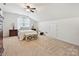 Bright bedroom featuring a ceiling fan and carpeted floors at 1109 Woodwinds Dr, Waxhaw, NC 28173