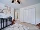 bedroom with a crib and closet at 1109 Woodwinds Dr, Waxhaw, NC 28173