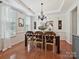 Dining room featuring a dark wood table, chandelier, and bright window with neutral decor at 1109 Woodwinds Dr, Waxhaw, NC 28173