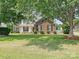 Attractive home exterior with brick accents and a well-maintained lawn adds to the property's charm at 1109 Woodwinds Dr, Waxhaw, NC 28173