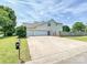 Home exterior features a three-car garage and a wide driveway, providing ample parking space at 1109 Woodwinds Dr, Waxhaw, NC 28173