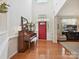 Bright foyer with hardwood floors, piano, and an open view into the living room; a welcoming entrance at 1109 Woodwinds Dr, Waxhaw, NC 28173