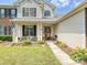 Close up of charming home's entrance, showcasing front porch, decorative door, and well-maintained lawn at 1109 Woodwinds Dr, Waxhaw, NC 28173