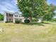 Beautiful home with well-kept lawn and mature trees creates an inviting and picturesque setting at 1109 Woodwinds Dr, Waxhaw, NC 28173