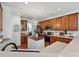 Modern kitchen with wooden cabinets, a central island, stainless steel appliances, and great lighting at 1109 Woodwinds Dr, Waxhaw, NC 28173