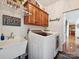 Practical laundry room with washer, dryer, and overhead storage cabinets at 1109 Woodwinds Dr, Waxhaw, NC 28173