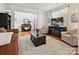 Inviting living room with hardwood floors, comfortable seating, and a decorative piano at 1109 Woodwinds Dr, Waxhaw, NC 28173