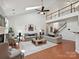 Bright living room features vaulted ceilings, fireplace, skylights, and hardwood floors at 1109 Woodwinds Dr, Waxhaw, NC 28173