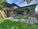 Expansive backyard with a patio, lush lawn, modern design, and outdoor seating for entertaining at 112 Manning Dr, Charlotte, NC 28209