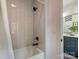 Bathroom with a white tiled tub/shower and views into the neighboring bathroom at 112 Manning Dr, Charlotte, NC 28209