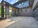 Carport with a wooden ceiling and paved driveway providing ample parking; home is brick and siding at 112 Manning Dr, Charlotte, NC 28209