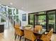 Bright dining room with statement light fixture, large windows, and access to the outdoor patio at 112 Manning Dr, Charlotte, NC 28209