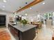 Open concept kitchen has stainless appliances, kitchen island and flows into dining area at 112 Manning Dr, Charlotte, NC 28209