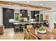 Modern kitchen with dark cabinets, an island with bar seating and adjacent dining at 112 Manning Dr, Charlotte, NC 28209