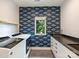 Laundry room features a side-by-side washer and dryer, blue wallpaper and window with natural light at 112 Manning Dr, Charlotte, NC 28209