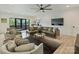 Comfortable living room with a sectional sofa, large TV, and access to an outdoor deck at 112 Manning Dr, Charlotte, NC 28209