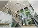 Bright, modern staircase with large windows and sleek black railings leads to the upper level of the home at 112 Manning Dr, Charlotte, NC 28209