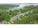 Aerial view of waterfront homes with mature trees, showcasing neighborhood and lake views at 118 Tuscany Trl, Mooresville, NC 28117