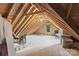 A spacious unfinished attic with exposed beams and a single window, ready for storage or renovation at 118 Tuscany Trl, Mooresville, NC 28117
