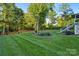 Beautifully landscaped backyard featuring lush lawn and manicured garden beds, perfect for outdoor enjoyment at 118 Tuscany Trl, Mooresville, NC 28117