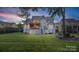 Lush backyard showcasing a two-story home with a screened porch and well-kept landscaping at 118 Tuscany Trl, Mooresville, NC 28117