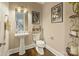 Charming powder room features pedestal sink, decorative mirror, and tasteful wall decor at 118 Tuscany Trl, Mooresville, NC 28117