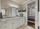 Bright primary bathroom with dual sinks, granite counters, and access to the primary bedroom at 118 Tuscany Trl, Mooresville, NC 28117