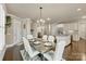 Formal dining room next to kitchen features a large table with seating and a view of the front yard at 118 Tuscany Trl, Mooresville, NC 28117