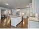 Open kitchen design with granite island, stainless appliances, and hardwood flooring throughout at 118 Tuscany Trl, Mooresville, NC 28117