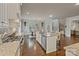 Spacious kitchen with granite countertops, stainless appliances, a large island, and an adjacent dining area at 118 Tuscany Trl, Mooresville, NC 28117