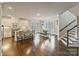 Open concept kitchen and dining area with modern finishes and a staircase at 118 Tuscany Trl, Mooresville, NC 28117