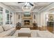 Bright living room showcasing a stone fireplace, coffered ceiling and large windows at 118 Tuscany Trl, Mooresville, NC 28117
