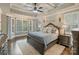 Tranquil primary bedroom with tray ceiling, large windows, and a plush bed with stylish decor at 118 Tuscany Trl, Mooresville, NC 28117