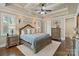 Serene primary bedroom with tray ceiling, large windows, hardwood floors, and elegant decor at 118 Tuscany Trl, Mooresville, NC 28117