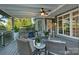 Cozy screened porch with plush seating, a ceiling fan, and outdoor fireplace at 118 Tuscany Trl, Mooresville, NC 28117