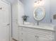 Modern bathroom featuring a sink with cabinet, a stylish oval mirror, and a decorative light fixture at 121 Quality Dr, Mount Holly, NC 28120