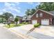 Brick townhome exterior with two car garage and manicured lawn at 121 Quality Dr, Mount Holly, NC 28120