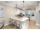 Bright kitchen with white cabinets, stainless steel appliances, and a center island with bar stools at 121 Quality Dr, Mount Holly, NC 28120