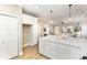 Bright kitchen featuring a quartz countertop island with pendant lighting, hardwood floors, and access to the living room at 121 Quality Dr, Mount Holly, NC 28120